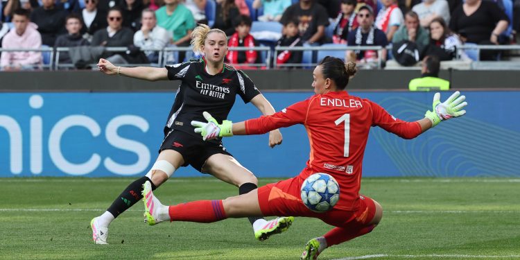 Alessia Russo of Arsenal scores her team's third goal past Christiane Endler of Olympique Lyonnais during the UEFA Women's Champions League semifinal second leg match between Olympique Lyonnais and Arsenal WFC at OL Stadium on April 27, 2025 in Decines-Charpieu, France.