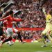 Manchester united score with aston villa players in the background
