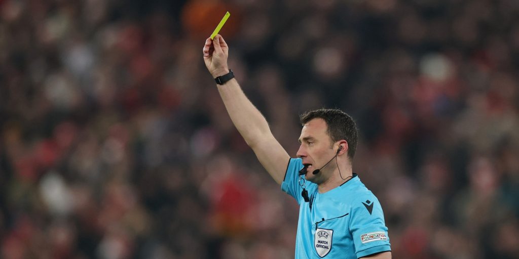 Referee Felix Zwayer showing a yellow card in the Champions League (Reuters)