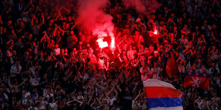 Olympique Lyonnais fans with flares in the stands (Reuters)