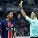 Paris St Germain's Marquinhos is shown a yellow card by referee Jerome Brisard (Reuters)