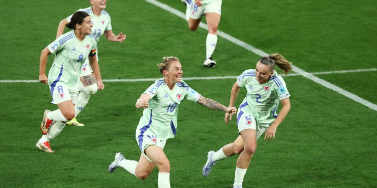 Wales' Jessica Fishlock celebrates scoring their first goal with Lily Woodham (Reuters)