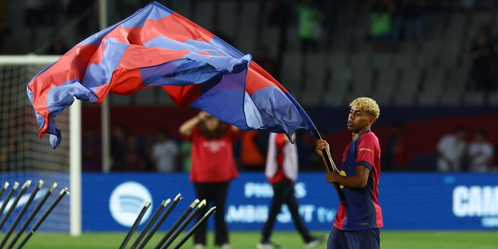 FC Barcelona's Lamine Yamal celebrates with a flag after winning LaLiga (Reuters)