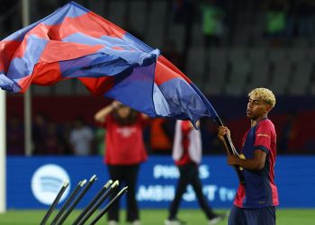 FC Barcelona's Lamine Yamal celebrates with a flag after winning LaLiga (Reuters)
