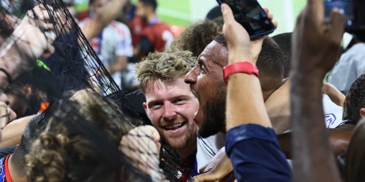 Pavel Sulc and Corentin Tolisso celebrate Lyon's goal against Marseille (Reuters)
