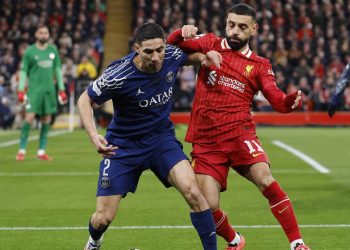 Paris St Germain's Achraf Hakimi in action with Liverpool's Mohamed Salah (Reuters)