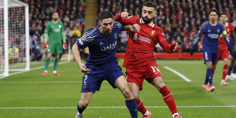 Paris St Germain's Achraf Hakimi in action with Liverpool's Mohamed Salah (Reuters)