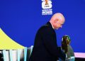 FIFA president Gianni Infantino holds the World Cup trophy after the playoffs draw (Reuters)